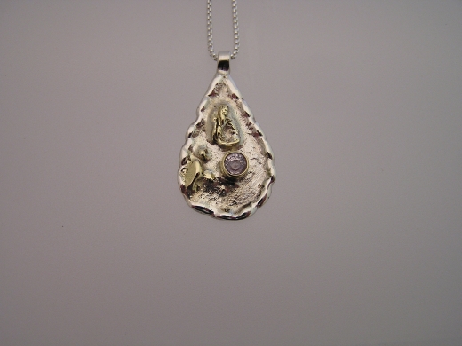 Silver & 18ct gold pendant with very pale lilac Sapphire